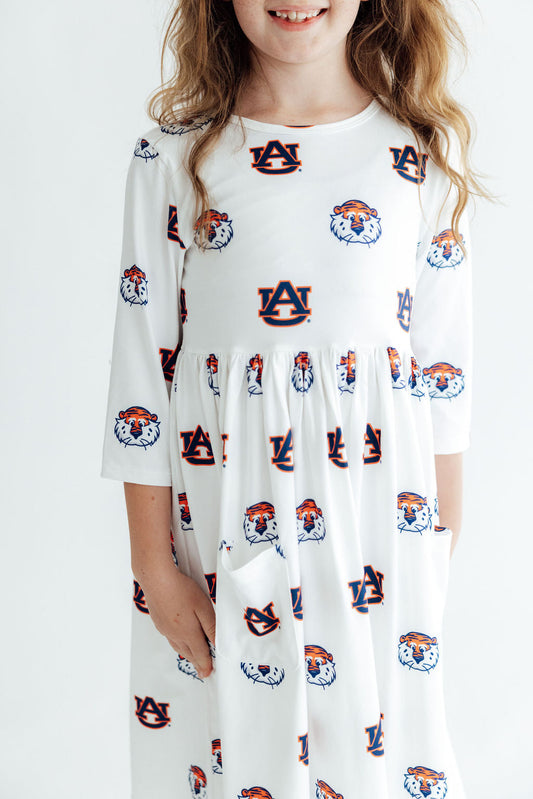 Girls white three-quarter sleeve dress with an all-over Auburn Tigers logo print